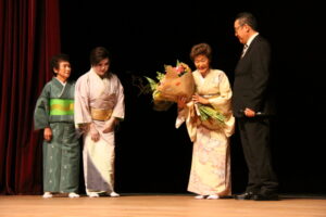 門下生から花束を受け取った龍千多さん(右から2人目)