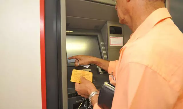 現金自動預け払い機を利用する男性（© Arquivo/ Agência Brasil）