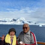 南極大陸をバックに記念撮影、ことじさんと佳和さん（本人提供）