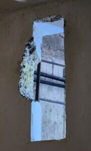 独房内の壁を壊し、蓋や枠を外した後の照明器用の穴とその背後にあるシャフトを写した写真（Divulgação）